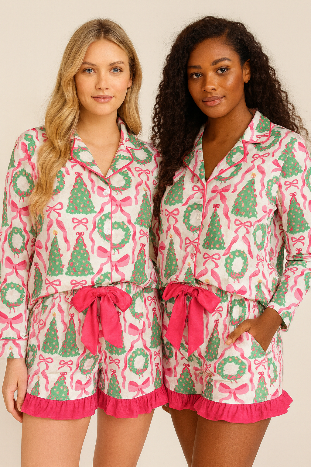 Two women wearing matching pink and green pajama sets with festive patterns on a beige background.