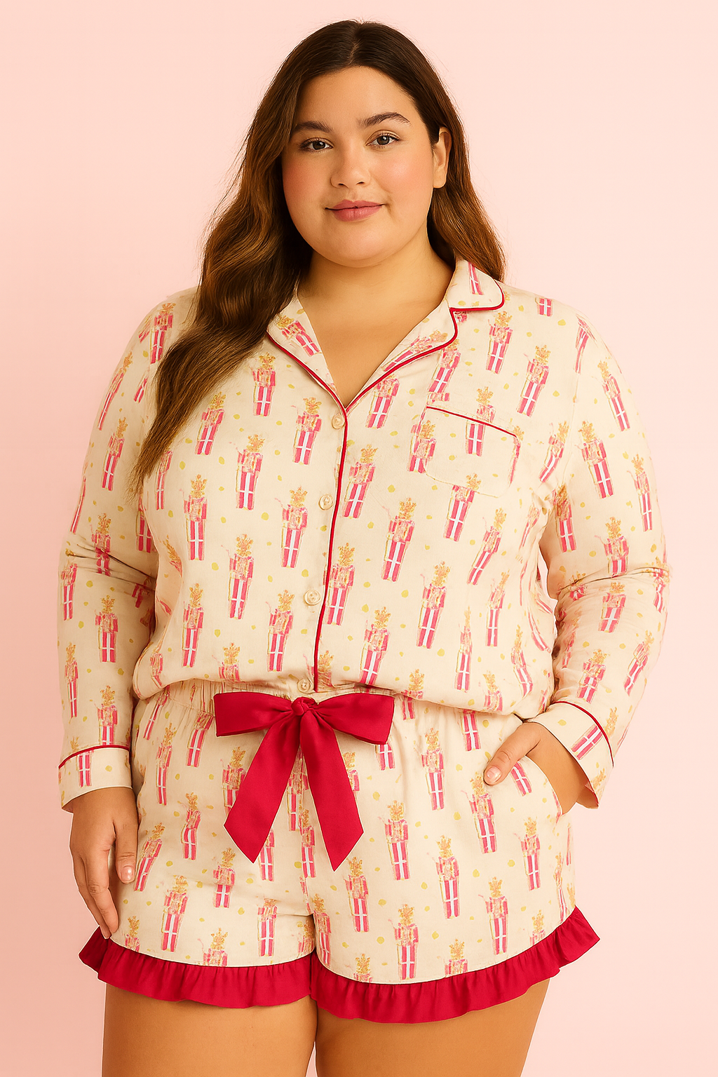 Woman wearing a pajama set with a pink bow on a pink background