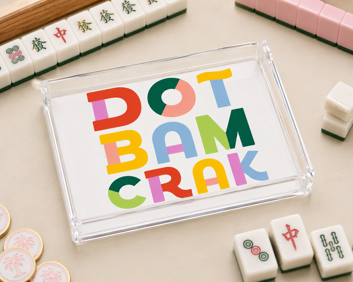 Colorful 'Dot Bam Crak' sign with Mahjong tiles on a light surface