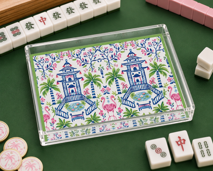 Decorative box with floral and pagoda design on a green surface with Mahjong tiles.