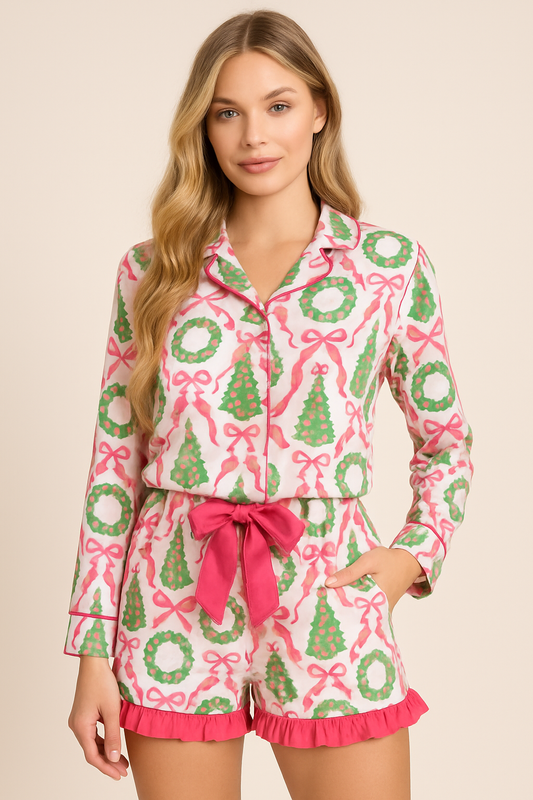 Woman wearing a festive pajama set with wreath and bow pattern on a beige background