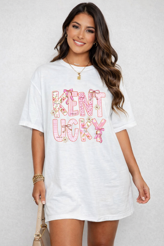 Woman wearing a white t-shirt with 'Kentucky' printed in colorful letters on a plain background