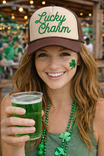 Woman wearing a 'Lucky Charm' cap, holding a green drink, with a shamrock on her cheek, in a festive setting.