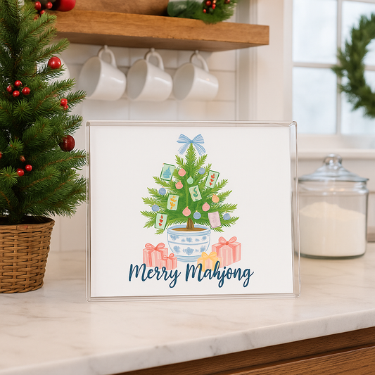 Framed artwork of a Christmas tree with presents on a kitchen counter.