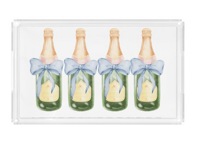 Four champagne bottles with blue bows on a white background